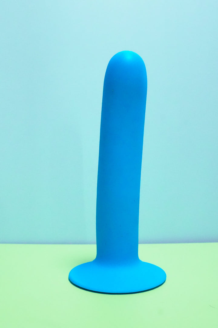 Blue cylindrical object on a green and blue gradient background