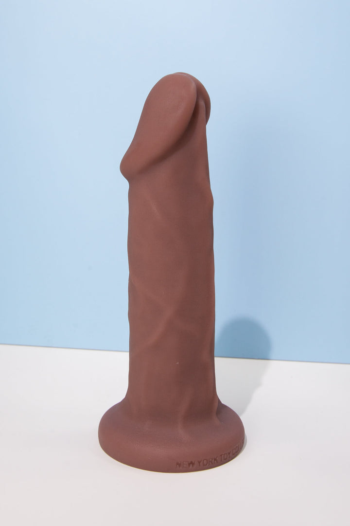 Brown silicone product on a white surface with a light blue background