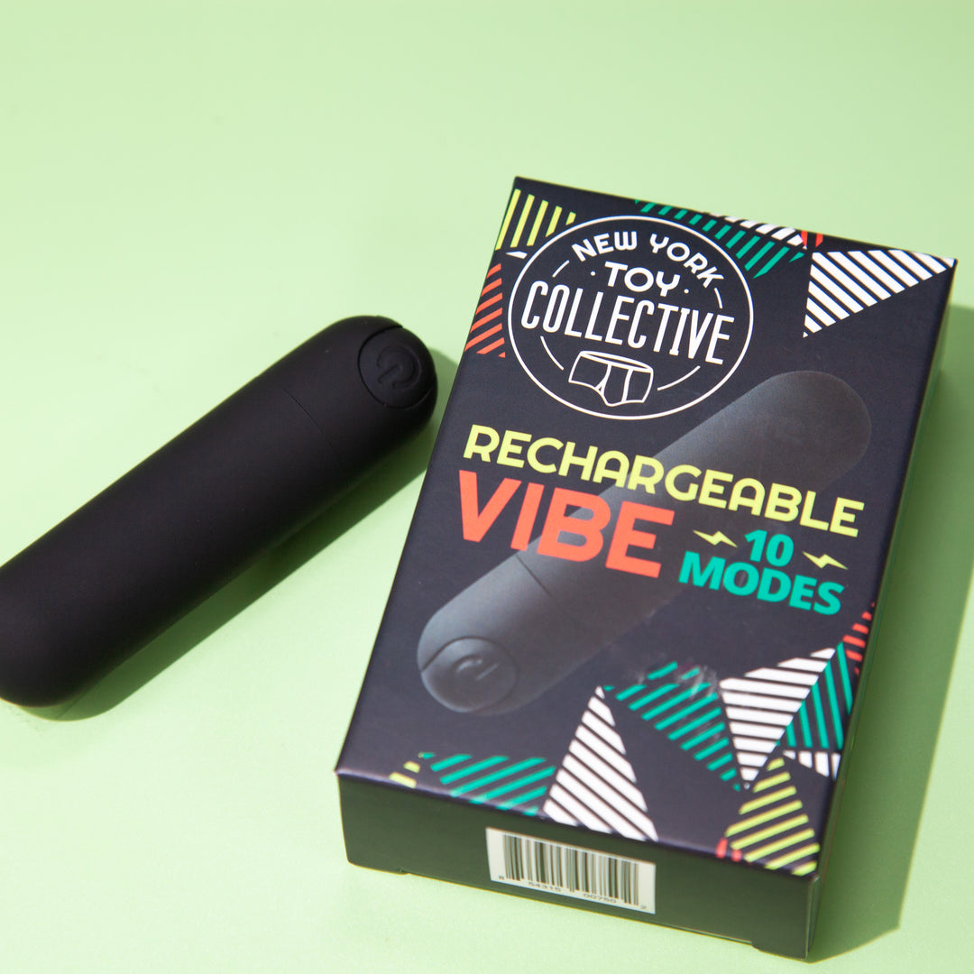 Black bullet vibrator beside its retail box